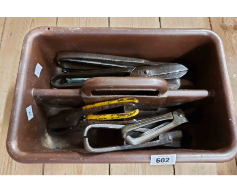 A plastic tool tray containing a quantity of old tin snips