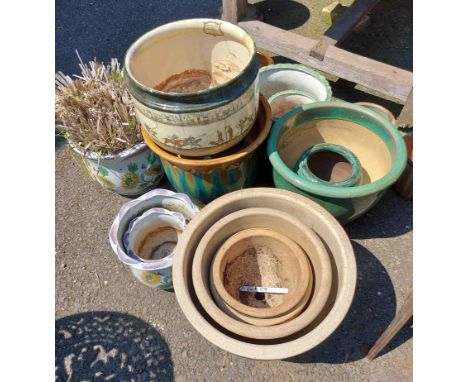 A large quantity of ceramic garden pots of varying design and finish