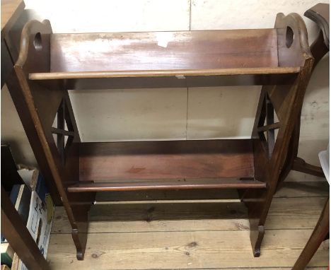A 60cm Edwardian mahogany two tier book trough, set on shaped and pierced standard ends