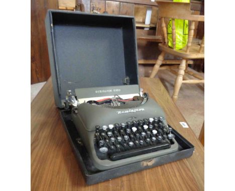 A vintage portable Remington Rand typewriter in original hard carry case