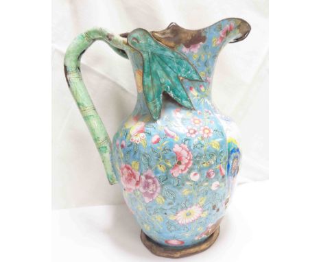 An antique Chinese enamelled jug with central panel depicting figures in a garden and a fruit and floral border - losses and 