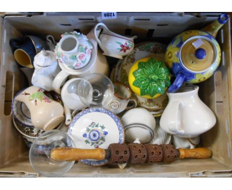 A crate containing a quantity of assorted ceramic and glass items including teapots, plates, etc.