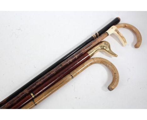 Five 20th Century walking sticks, to include a bone handled example, a brass handled stick in the form of a duck's head, open