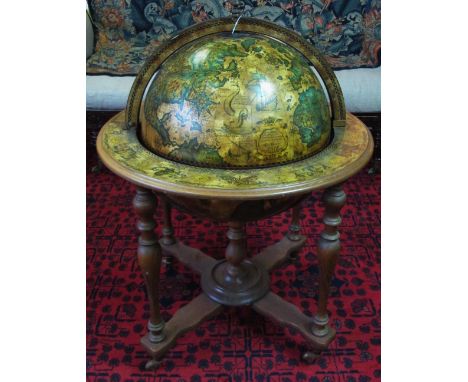 COCKTAIL GLOBE, circa 1970, with fitted interior on beechwood baluster supports, 96cm H x 76cm D. 