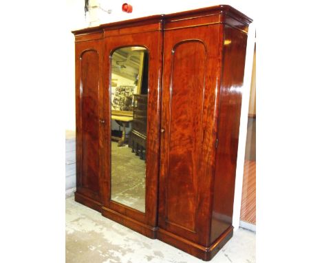 BREAKFRONT WARDROBE, Victorian mahogany with mirror door flanked by panel doors enclosing hanging space and four drawers, 214