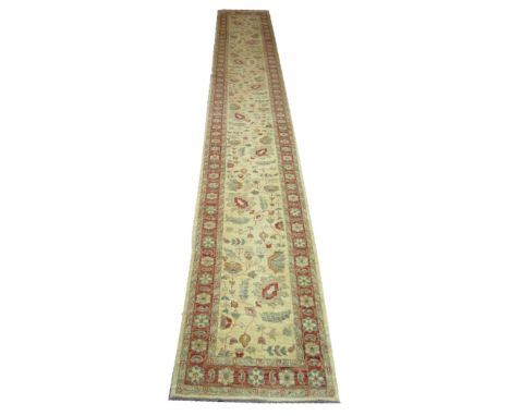 QABUL ZIEGLER STYLE RUNNER, 558cm x 78cm, palmettes and vines on an ivory field within bands and border.