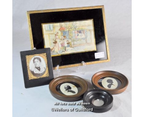 A Victorian portrait photograph in ebonised frame; two inked silhouettes in small circular frames; a further circular frame; 