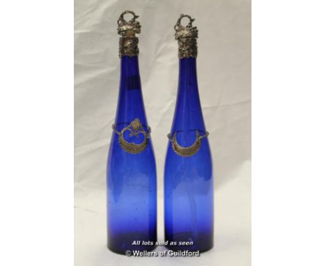 A pair of blue glass bottles with silver mounts and silver wine decanter labels, 'Tenerife' and 'White port'