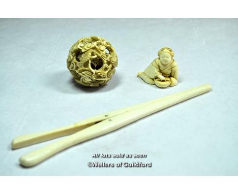 Ivory netsuke of a seated woman, signed; pierced ivory ball; ivory glove stretchers.