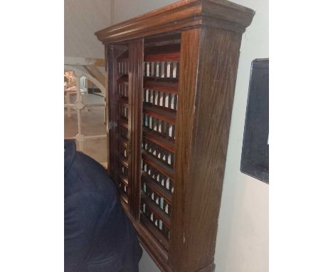 The Station An oak railway ticket dispensing machine An oak railway ticket dispenser with 7 shelves, each with 15 ticket comp