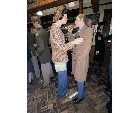 Britain in the Blitz Lady & Gentleman in Period Costume A lady &amp; gentleman in the Pub wearing period costume. She wears a