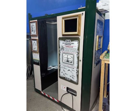 Outside Photo Booth & Change Machine. A "Create Your Own Portrait" photo booth &amp; a change machine, both in need of attent