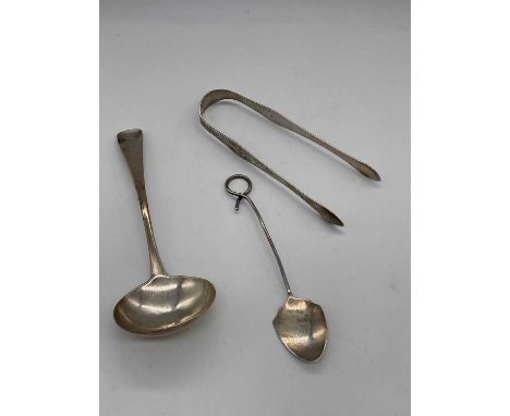 A George IV hallmarked silver sauce ladle with engraved initials to the terminal, London 1828, a pair of hallmarked silver su