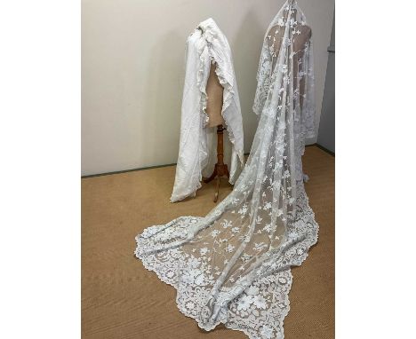 A vintage embroidered and appliquéd tulle panel, used as a curtain, length 4.5m x 1.87m ( some discolouration), also with a v