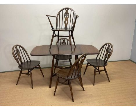 ERCOL; a drop-leaf table, length including extensions 138cm, height 73cm, with one carver and four dining chairs (6).