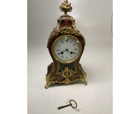 A late 19th century French Boullework style gilt metal mounted eight-day mantel clock with Roman numerals to the white enamel