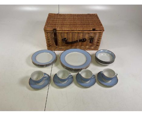 A Doulton part dinner service comprising four dinner plates, four side plates, four bowls, four cups and saucers, housed in a