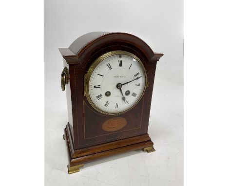 An Edwardian mahogany and inlaid eight-day bracket clock with ogee moulded brass feet, circular white enamel dial set with Ro