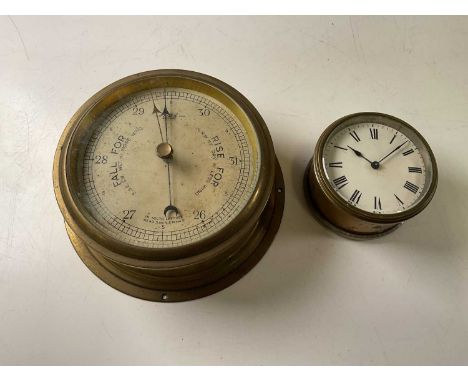 A Sestral barometer, face diameter 18cm, and a ship's clock, no maker's mark, 10cm diameter