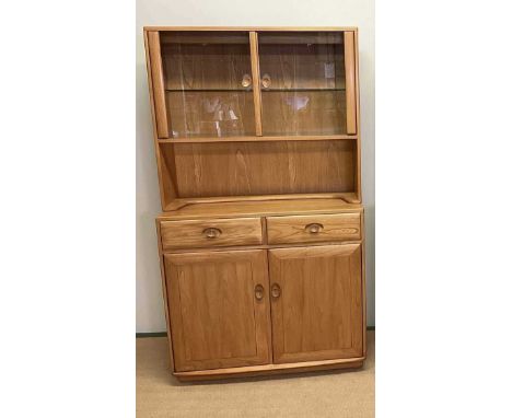 ERCOL; an elm glazed cabinet with cupboards to base, height 185cm, width 105cm, depth 54cm 