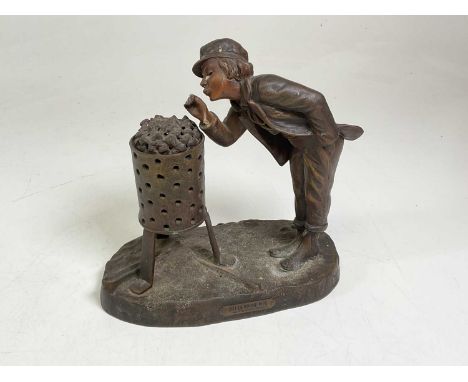 AFTER A DE RANIERI; a French spelter table lamp modelled as a boy lighting a pipe, height 26cm.