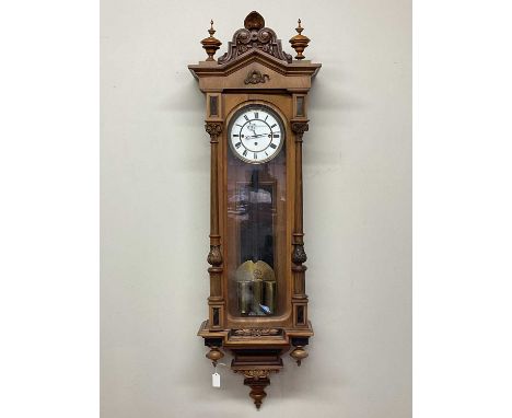 A late 19th century walnut triple weight regulator Vienna style wall clock with two piece white enamel dial set with Roman nu