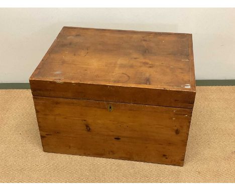 A pine trunk with brass handles, height 38cm, width 58cm, depth 44cm.