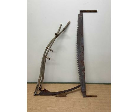 A two man saw and two scythes.