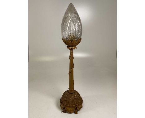 An early 20th century gilded over brass lamp swags and tails base with cut glass tapered shade, height 76cm.