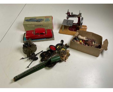 A quantity of toys including lead farm animals, Meccano and a Tri-ang Ford Zephyr and a child's sewing machine, plus an Astra