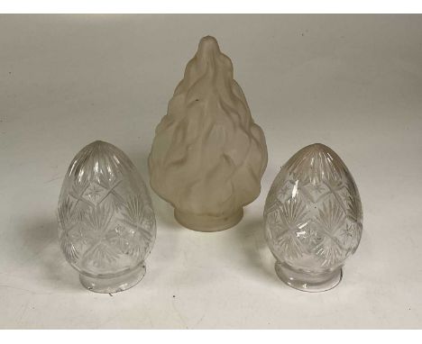 A pair of cut glass lamp shades and a frosted glass shade in the form of flames, height 27cm (3).