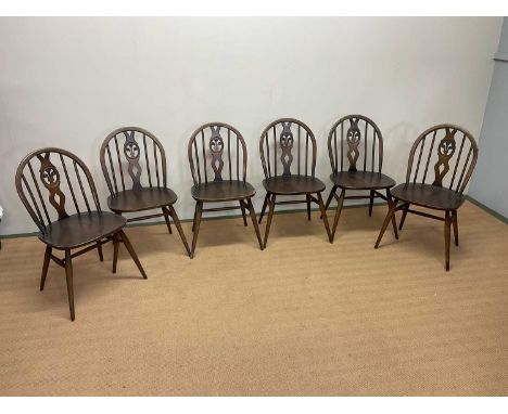 ERCOL; a set of six dining chairs with fleur de lys backs, height 80cm, width 42cm.