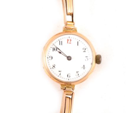 A lady's 15 carat yellow gold wrist watch, 23mm white enamel arabic dial in a 15 carat yellow gold case hallmarked London (im