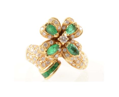 An emerald and diamond fancy floral design cluster ring, four marquise cut emeralds each set to the centre of a petal and sur