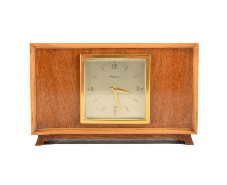 An Elliott walnut mantel clock, the shaped case in Art Deco style with stainwood trim, retailed by Pearce &amp; Sons, Leicest