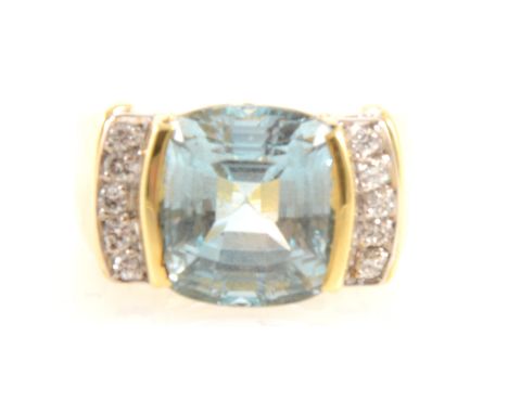 A blue topaz and diamond ring, the cushion shaped step cut blue topaz 11.5mm x 11.5mm x 9.2mm set in a yellow and white metal