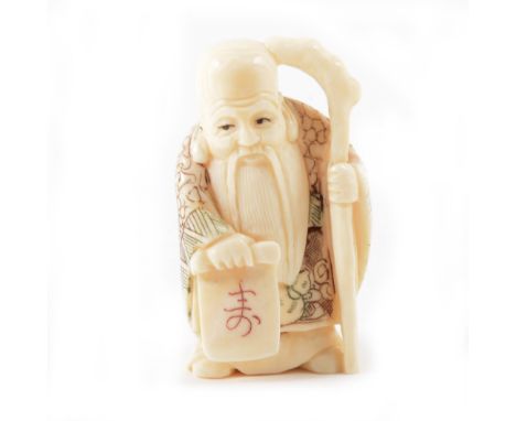 Japanese netsuke of an elder holding a scroll, stained detailing, two character mark, 5cm.