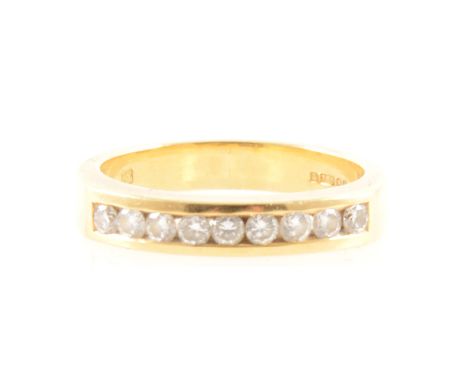 A diamond half eternity ring, nine brilliant cut diamonds channel set in an 18 carat all yellow gold mount 3.5mm wide, hallma