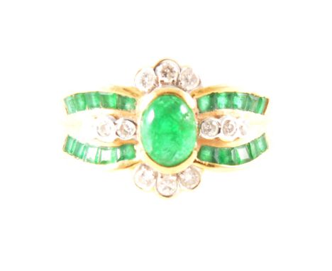 An emerald and diamond multi stone dress ring, a central oval cabochon cut emerald collet set with a band of square cut emera