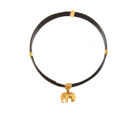 A three strand elephant hair bangle with four gold coloured retainers and elephant charm in a fitted jewel box bearing the na