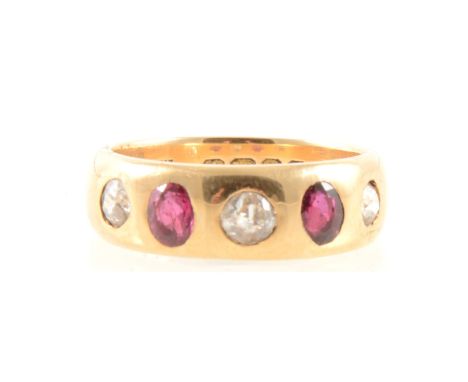 A ruby and diamond five stone ring, the two oval rubies and three old cut diamonds roman set in an 18 carat yellow gold band 