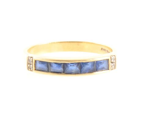 A sapphire and diamond half eternity ring, five square cut sapphires line edge set in an 18 carat all yellow gold mount 3.6mm