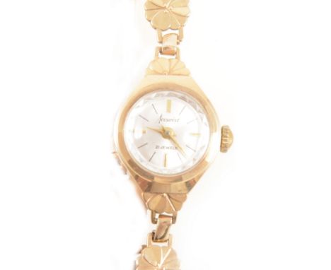 Accurist - a lady's 9 carat yellow gold bracelet watch, circular silvered baton dial with faceted glass and bezel in a 9 cara