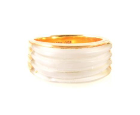 A frosted glass and yellow metal ring in the Art Deco style, the ridged frosted glass set in a yellow metal mount marked 18K 