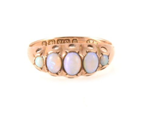 A five stone opal ring, the oval cabochon cut stones graduating in size rubbed over set in a 9 carat rose gold half hoop moun