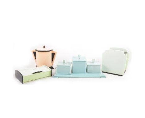 An Art Deco bakelite dressing table set, comprising three box and covers and a tray in pale blue; two stylised caddy and cove