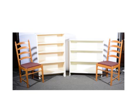 A pair of modern pine ladder-back dining chairs, upholstered seats, 102cm; and two painted bookcases. (4)