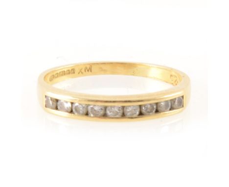 A diamond half eternity ring, nine brilliant cut diamonds channel set in an 18 carat all yellow gold mount 2.8mm wide at fron