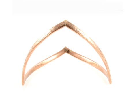 A rose metal upper arm bangle, 6mm wide V shape with engraved scroll design, internal diameter 9cm, marked 9ct B&amp;S, may b