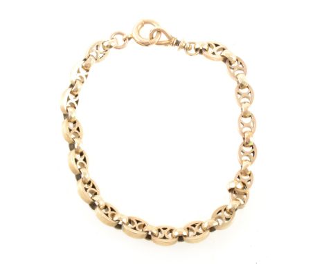 A yellow metal fancy link bracelet, 6.4mm gauge oval links with figure of eight to centre, overall length 21cm, broken bolt r